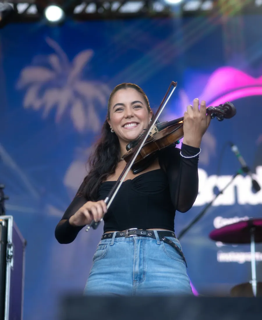 Violinista da Banda 4G sorrindo no palco